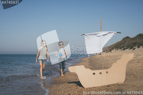 Image of Happy children playing on the beach at the day time.