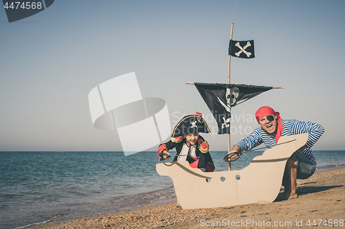 Image of Father and son playing on the beach at the day time.