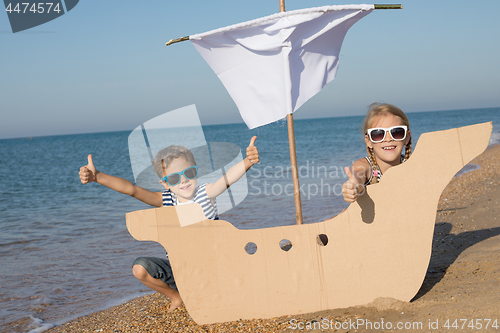 Image of Happy children playing on the beach at the day time.