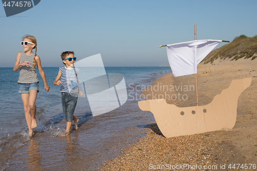 Image of Happy children playing on the beach at the day time.