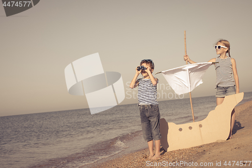 Image of Happy children playing on the beach at the day time.