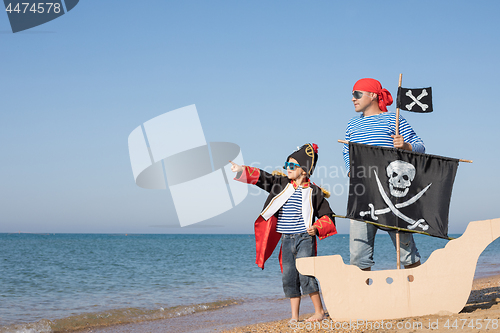 Image of Father and son playing on the beach at the day time.