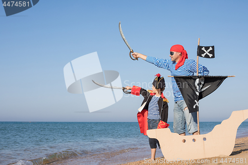 Image of Father and son playing on the beach at the day time.