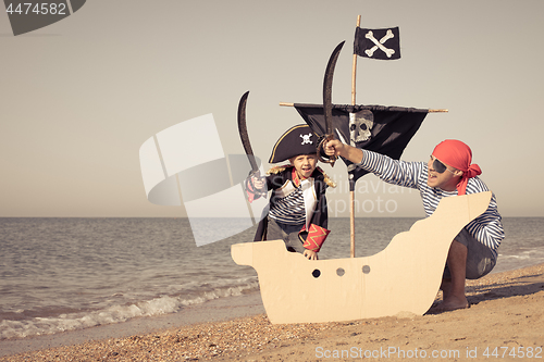 Image of Father and son playing on the beach at the day time.