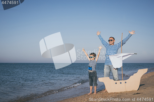 Image of Father and son playing on the beach at the day time.