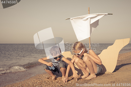 Image of Happy children playing on the beach at the day time.