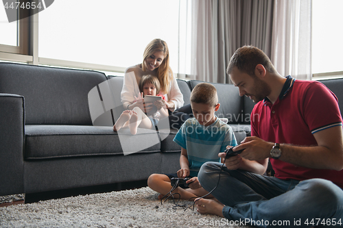 Image of Happy family playing a video game