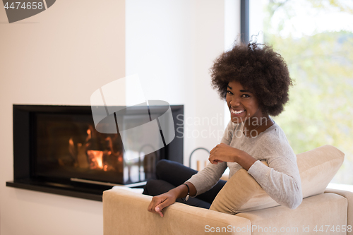 Image of black woman in front of fireplace