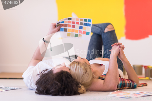 Image of Happy young couple relaxing after painting