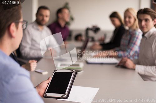 Image of Businessman using tablet in modern office