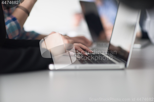 Image of group of business people having a meeting in bright office