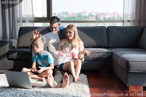 Image of Family Playing Together with laptop computer