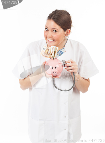 Image of happy woman doctor with piggy bank full of money