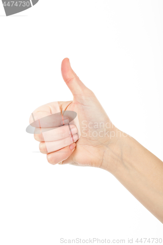 Image of Woman giving thumb-up for showing success. Woman\'s right hand is nice idea.