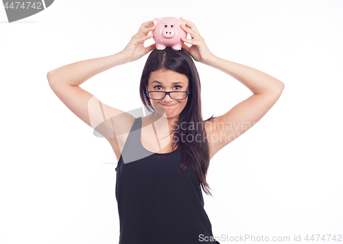 Image of Young woman hold a piggy bank