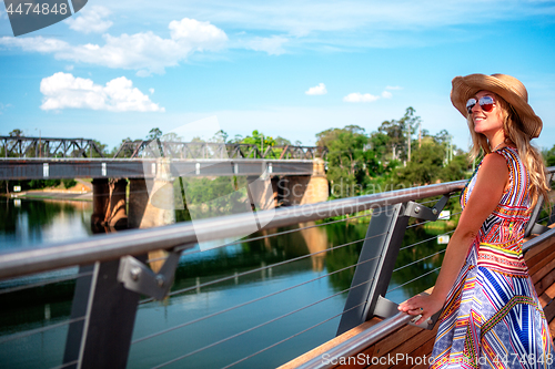 Image of Carefree girl enjoying the river views from the bridge at Penrith