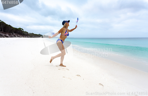 Image of Australian woman waving flags with joy