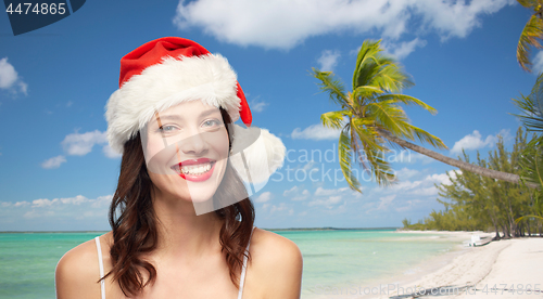 Image of woman with red lipstick in santa hat on christmas