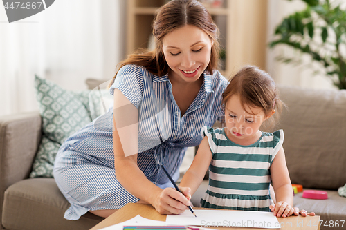 Image of pregnant mother and daughter drawing at home