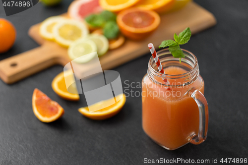 Image of mason jar glass of fruit juice on slate table top