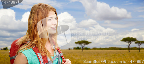 Image of happy woman with backpack over african savannah