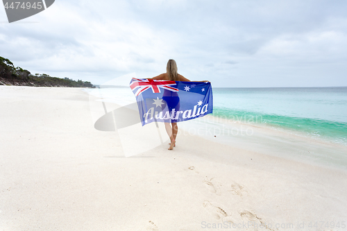 Image of Female on beach with Australian flag Australia Pride