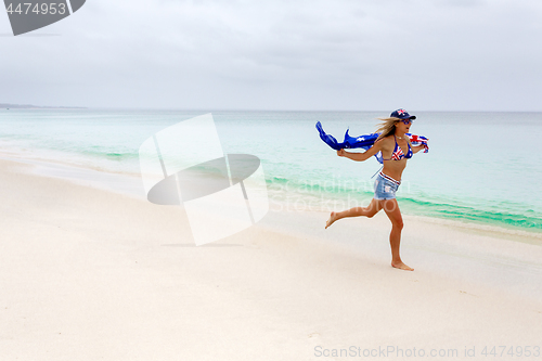 Image of Australian woman running along beach