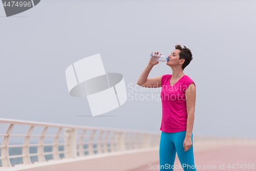 Image of Fitness woman drinking water