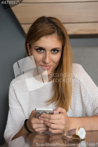 Image of young woman using mobile phone