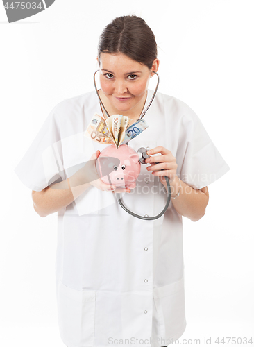 Image of happy woman doctor with piggy bank full of money