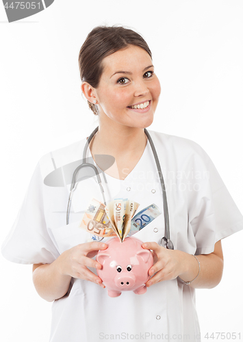 Image of happy woman doctor with piggy bank full of money