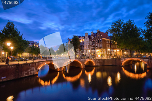 Image of Amterdam canal, bridge and medieval houses in the evening