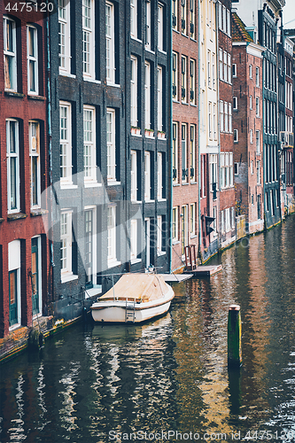 Image of Amsterdam canal Damrak with houses, Netherlands