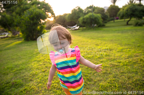 Image of little girl spending time at backyard