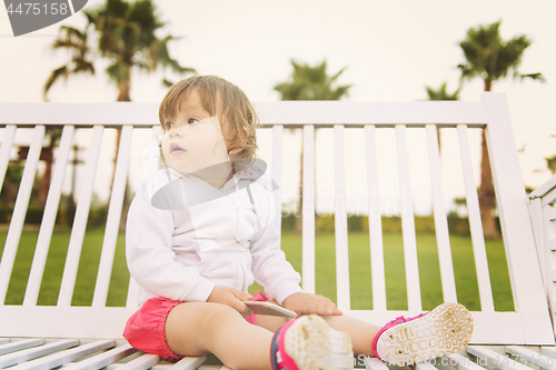 Image of little girl playing with mobile phone