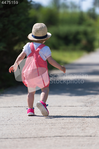 Image of little girl runing in the summer Park