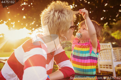 Image of mom and her little daughter using tablet computer