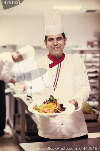 Image of Chef showing a plate of tasty meal