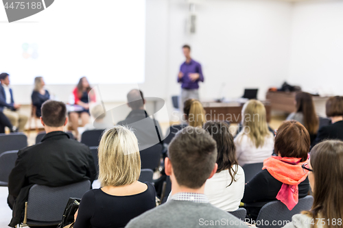 Image of Audience in lecture hall participating at business conference.