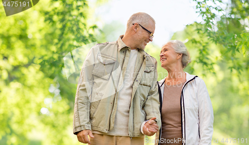 Image of happy senior couple over green natural background