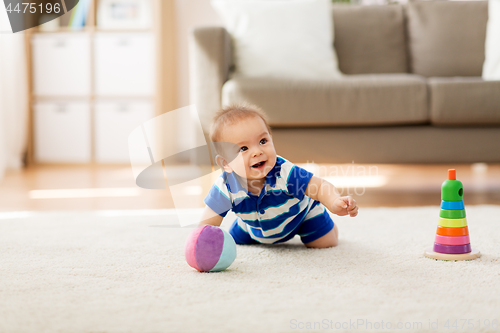 Image of sweet little asian baby boy with toys at home