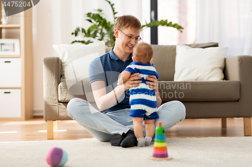 Image of happy father with baby son at home