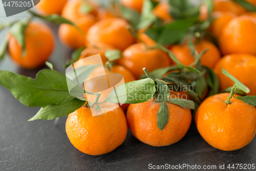 Image of close up of mandarins on slate table top