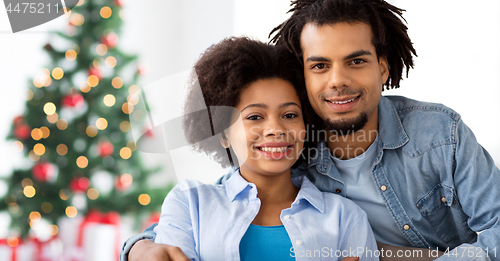 Image of happy couple hugging on christmas