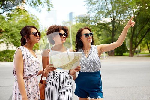 Image of happy women with map on street in summer city