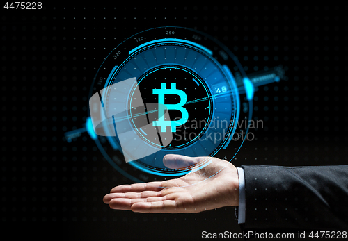 Image of buisnessman hand with bitcoin hologram