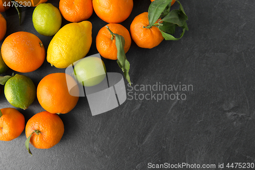 Image of close up of citrus fruits on stone table