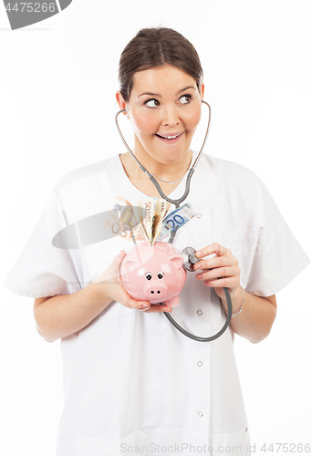 Image of happy woman doctor with piggy bank full of money