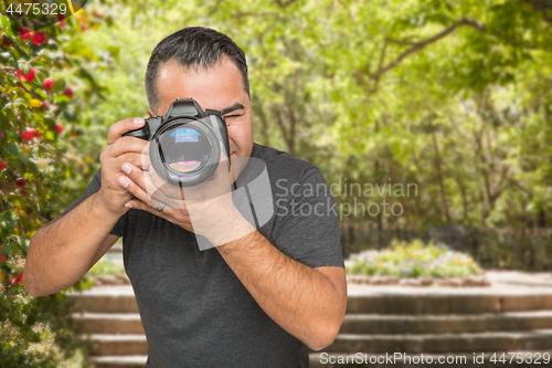 Image of Hispanic Young Male Photographer With DSLR Camera Outdoors