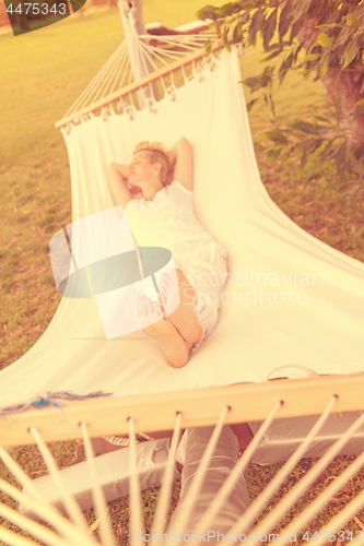 Image of young woman resting on hammock